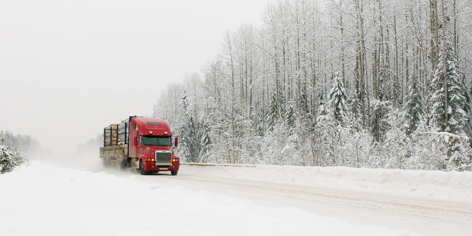 winter-driving-tips Red transport truck driving in winter