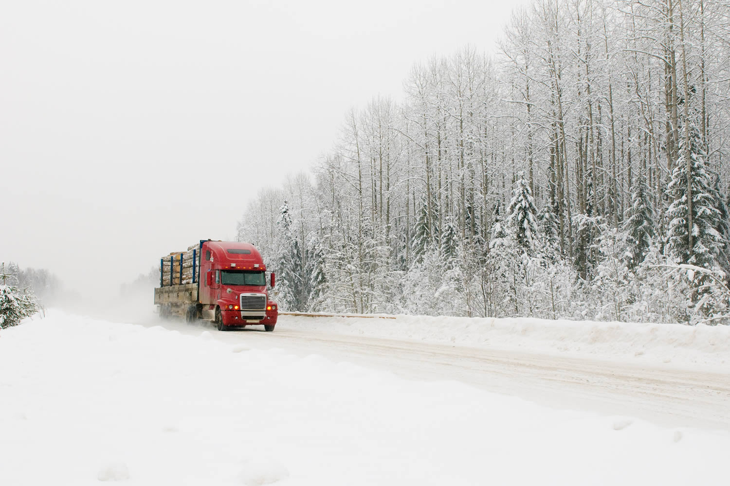 winter-driving-tips Red transport truck driving in winter