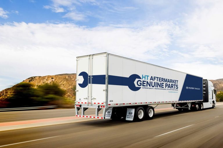 the Hyundai Translead truck on a highway with writing on the side that says HT Aftermarket Genuine Parts