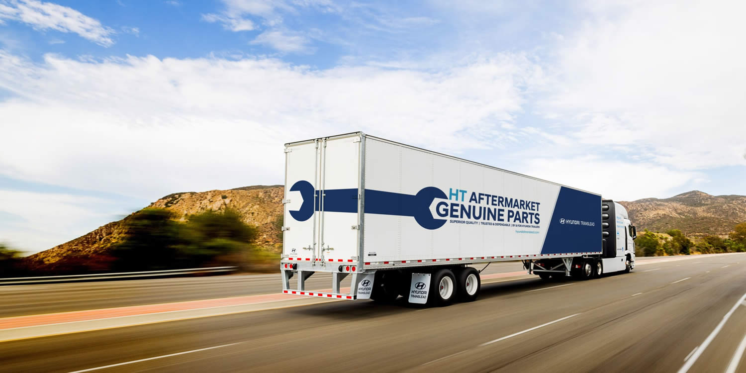 HT Aftermarket Parts at Breadner Trailers the Hyundai Translead truck on a highway with writing on the side that says HT Aftermarket Genuine Parts